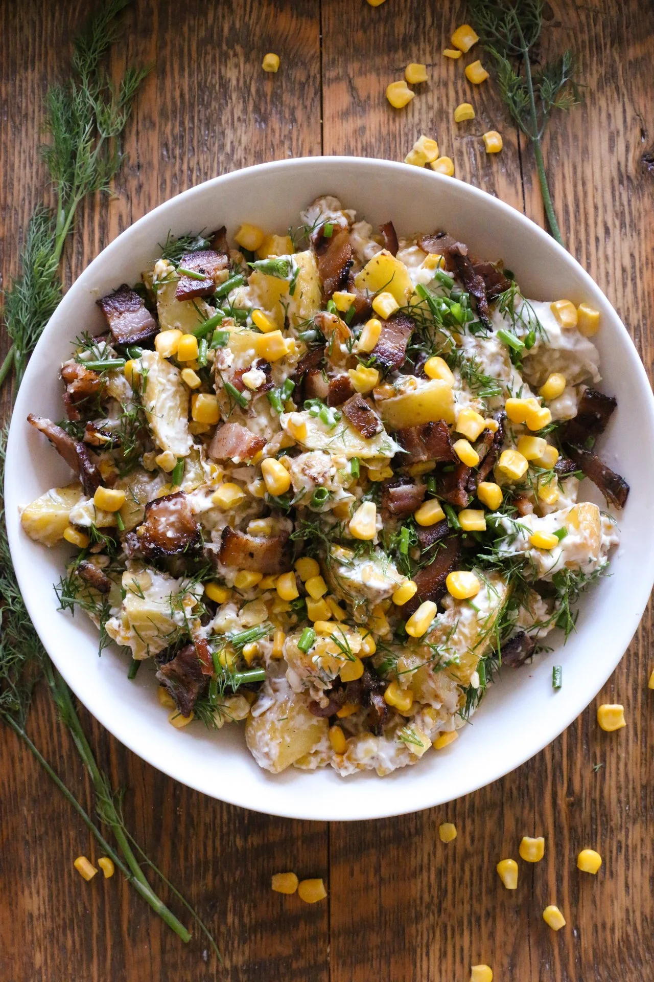 Earl's Warm Potato Salad served in a bowl with fresh herbs and spices.