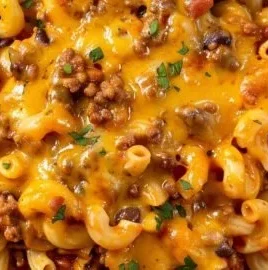 Bowl of easy chili mac topped with cheese and green onions