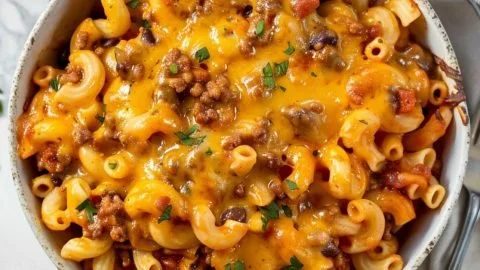 Bowl of easy chili mac topped with cheese and green onions