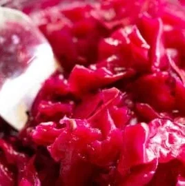 Jar of easy red cabbage sauerkraut fermenting on the kitchen counter