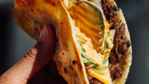 Delicious easy smash burger tacos garnished with fresh toppings