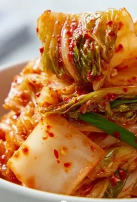 Bowl of homemade fermented cabbage kimchi with vibrant red seasoning
