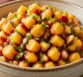 Bowl of fresh peach salsa made with ripe peaches, onions, and cilantro