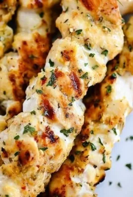 Grilled Garlic Parmesan Chicken Kebabs on a plate with herbs