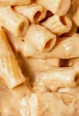 Delicious Garlic Parmesan Chicken Pasta topped with herbs and freshly grated cheese