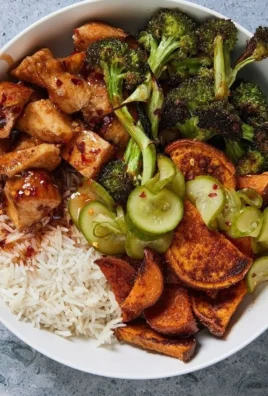 Hot honey chicken bowls with vibrant vegetables and spicy honey drizzle.