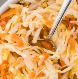 Bowl of homemade fermented coleslaw with vibrant vegetables and spices.