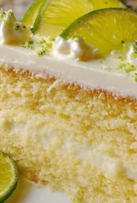 Delicious slice of Key Lime Cake with lime garnish on a white plate