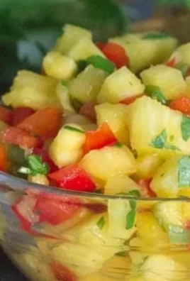 Bowl of low FODMAP pineapple salsa with colorful ingredients.