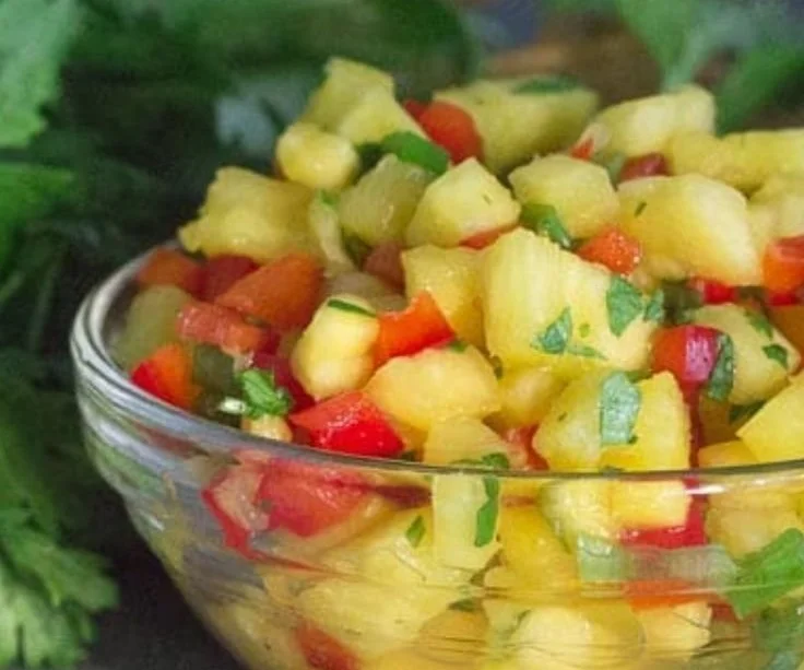 Bowl of low FODMAP pineapple salsa with colorful ingredients.