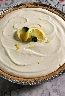 No Bake Lemonade Pie topped with whipped cream and lemon slices