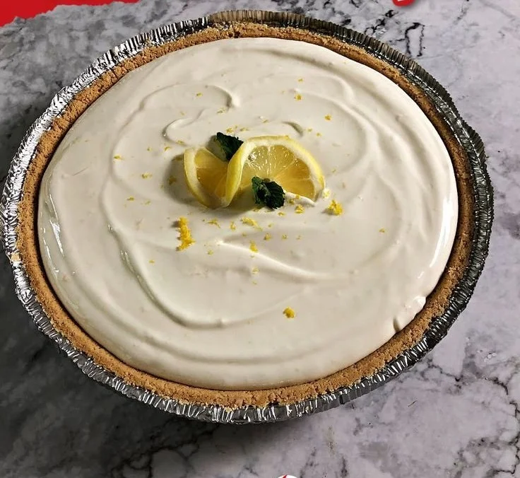 No Bake Lemonade Pie topped with whipped cream and lemon slices