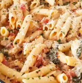 One Pot Creamy Chicken Pasta served in a bowl with herbs and garnishes