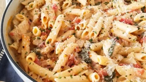 One Pot Creamy Chicken Pasta served in a bowl with herbs and garnishes