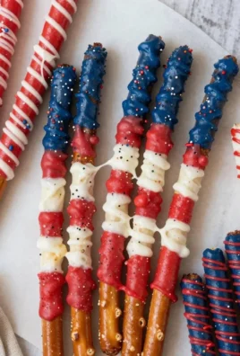 Festive patriotic pretzel rods decorated with red, white, and blue sprinkles.