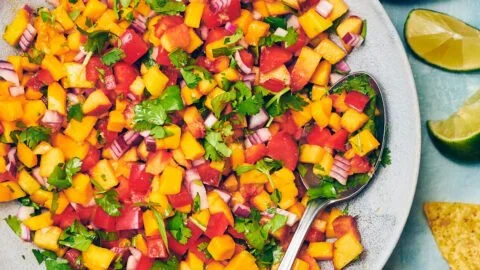 Fresh homemade Peach Mango Salsa with colorful fruits and herbs