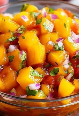 Fresh homemade peach salsa with chopped peaches, cilantro, and lime