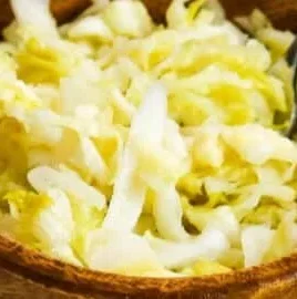 Homemade raw sauerkraut in a glass jar, showcasing its vibrant colors and natural fermentation.