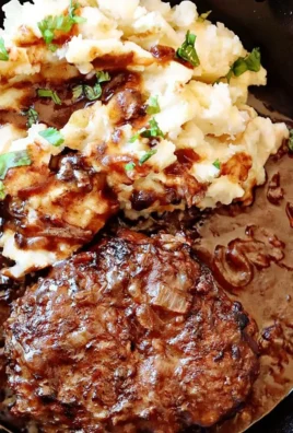 Delicious Salisbury Steak served with gravy and sides on a plate