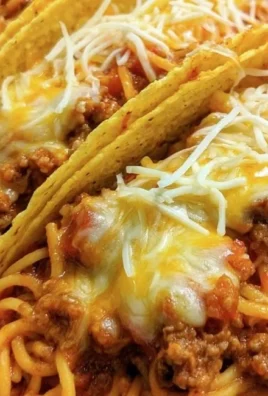 Spaghetti tacos with ground beef served on a plate