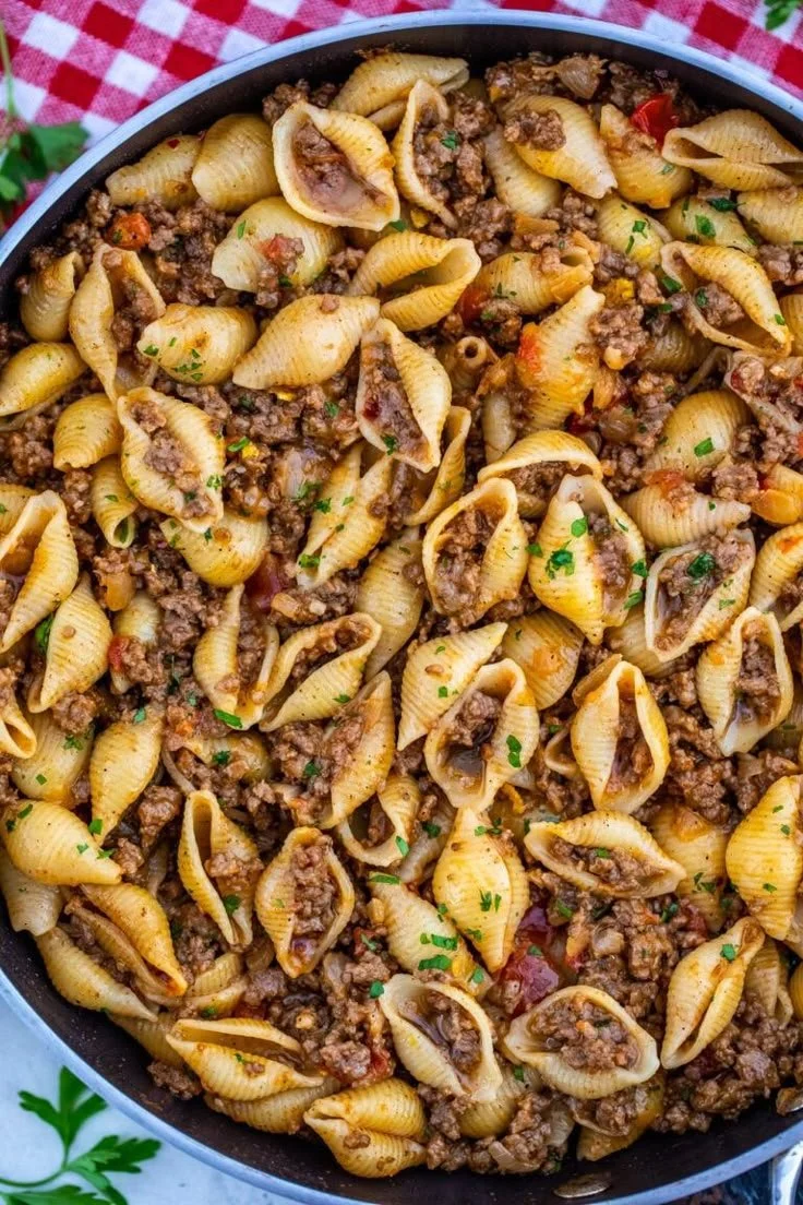 Delicious taco pasta dish topped with cheese and herbs