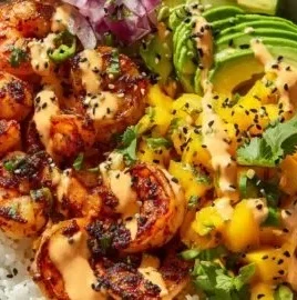 Delicious charred shrimp served in an avocado bowl with vibrant ingredients