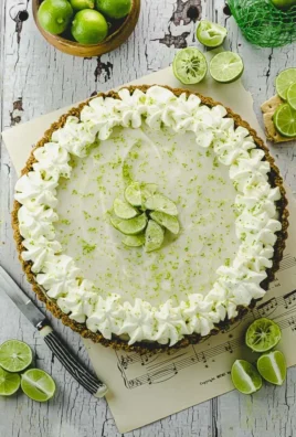 A slice of Vegan Key Lime Pie Tart garnished with lime slices