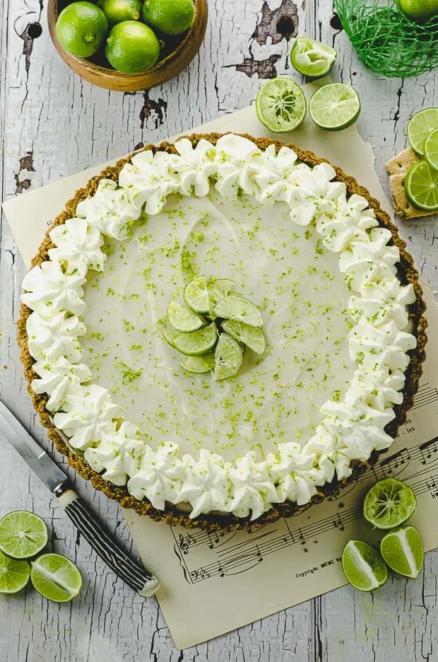 A slice of Vegan Key Lime Pie Tart garnished with lime slices