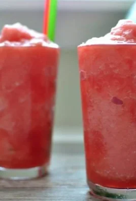 A refreshing watermelon slush in a chilled cup, perfect for summer days
