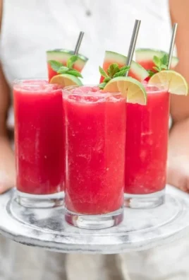 Refreshing watermelon slushie in a glass with mint garnish