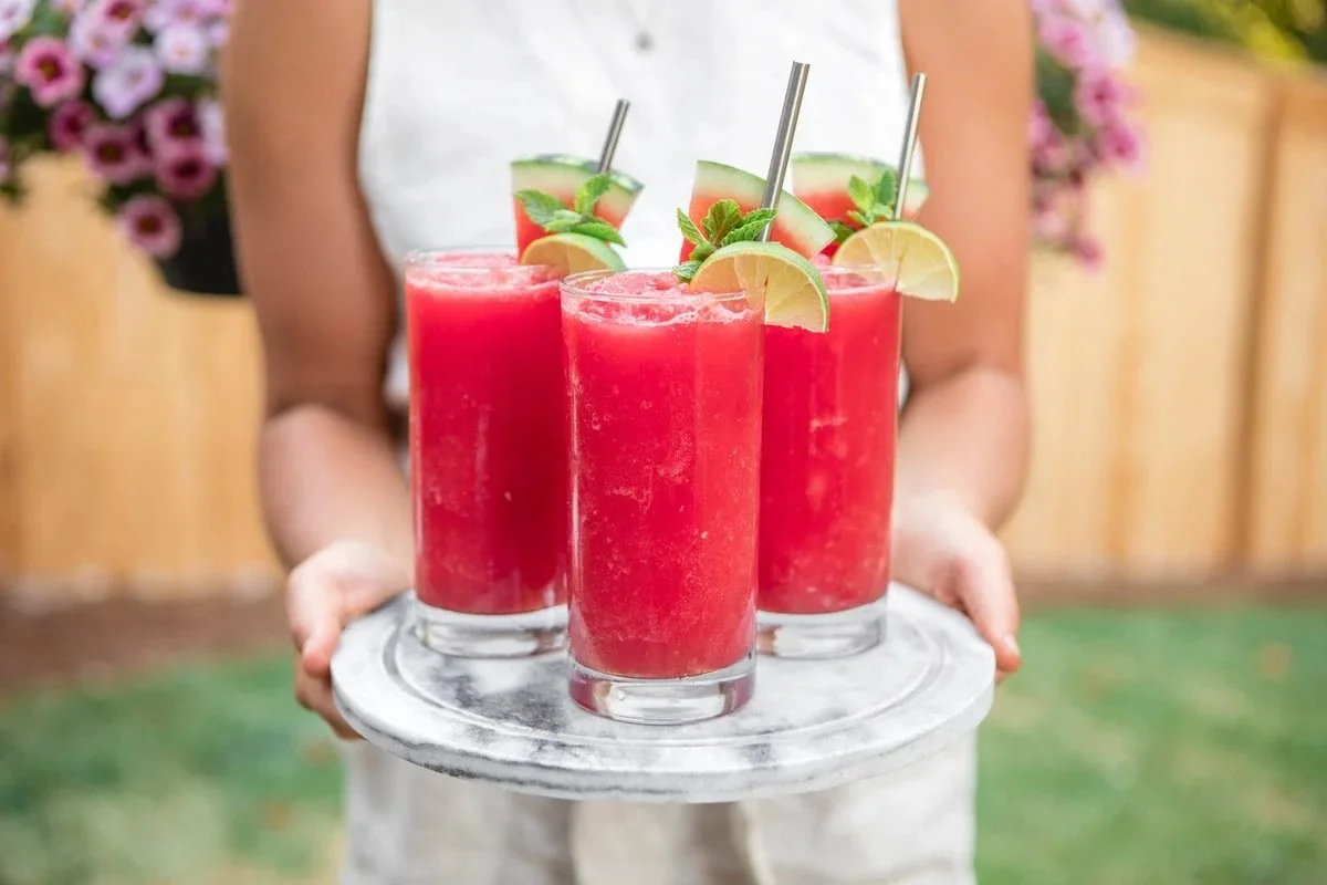 Refreshing watermelon slushie in a glass with mint garnish