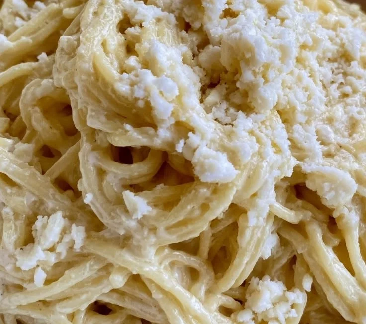 Plate of White Spaghetti garnished with fresh herbs and cheese
