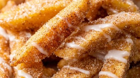 Crispy air fryer apple fries served in a bowl with a caramel dip