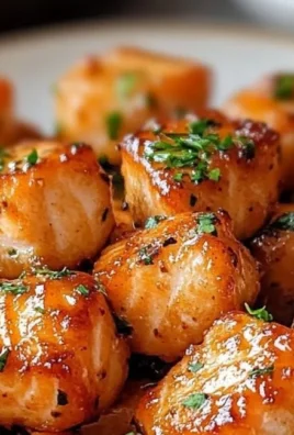 Delicious air fryer honey garlic salmon bites served with fresh herbs.
