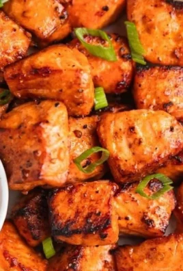 Air fryer salmon bites with Bang Bang sauce on a plate