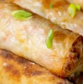 Crispy air fryer spring rolls served with dipping sauce