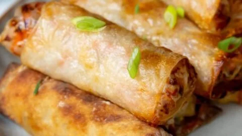Crispy air fryer spring rolls served with dipping sauce