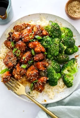 Delicious Air Fryer Teriyaki Chicken garnished with sesame seeds and green onions.