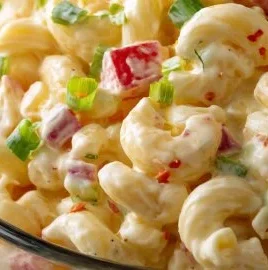 Delicious Amish Macaroni Salad served in a bowl with vegetables and dressing.