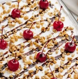 Deliciously layered Banana Split Cake topped with whipped cream and cherries