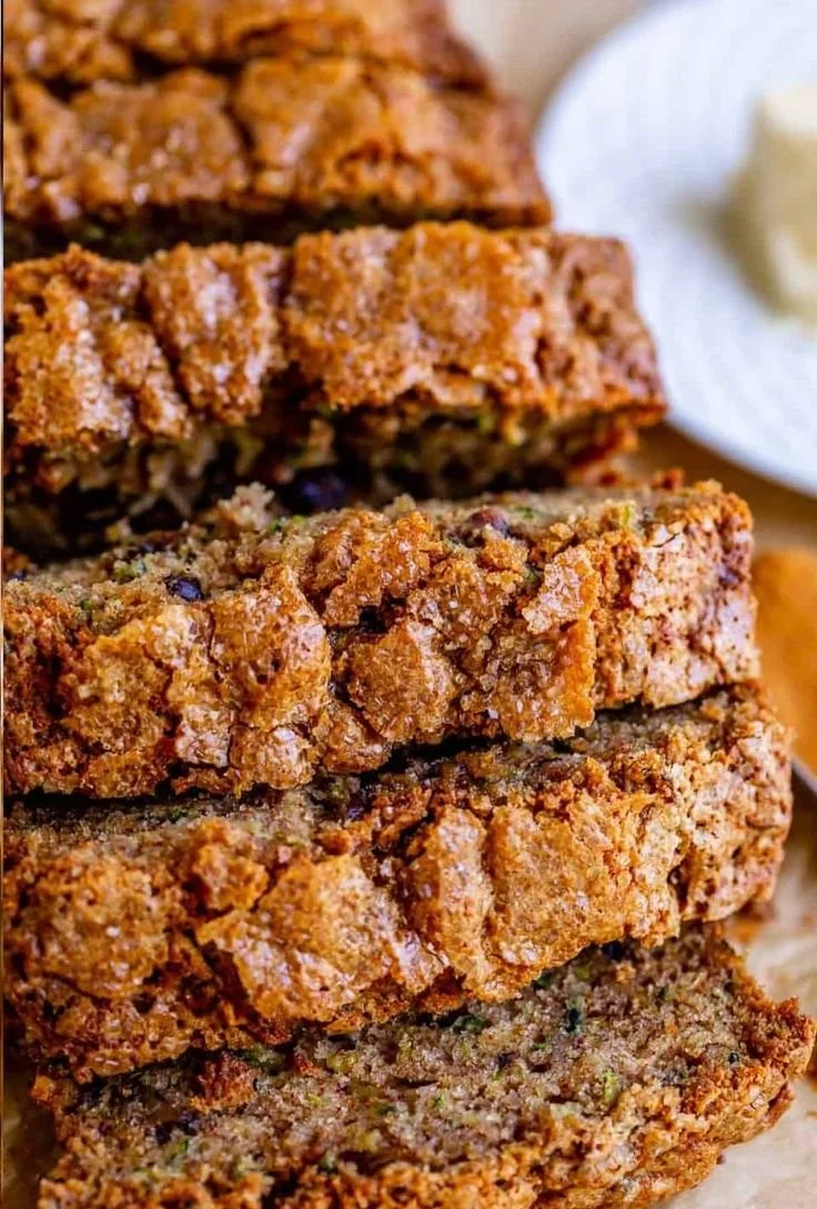 Delicious slice of homemade zucchini bread on a wooden table