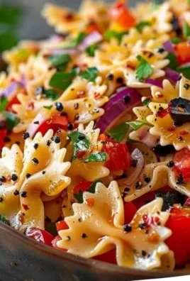 Colorful bow tie pasta salad with fresh vegetables and dressing