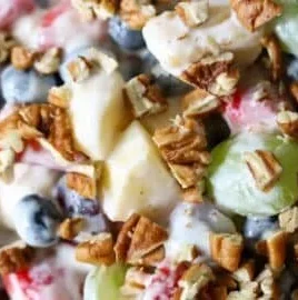 Colorful breakfast fruit salad with various fresh fruits in a bowl.