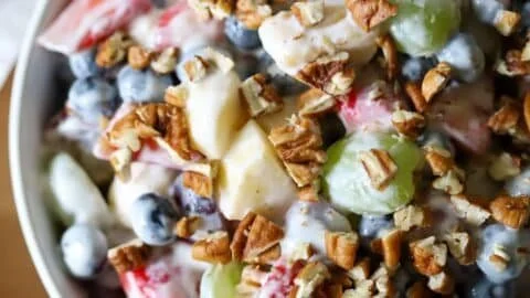 Colorful breakfast fruit salad with various fresh fruits in a bowl.