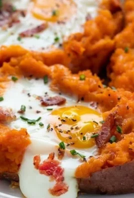 Healthy Breakfast Sweet Potato dish topped with eggs and herbs
