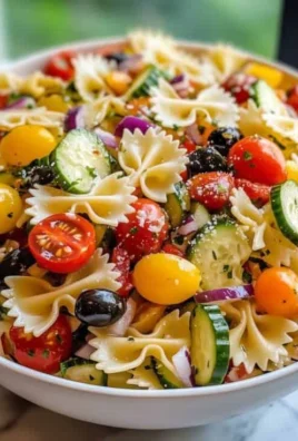 Bowl of colorful California pasta salad with vegetables and dressing