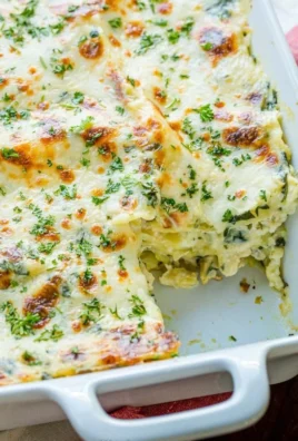 A delicious plate of cheesy chicken lasagna layered with creamy sauce and melted cheese.