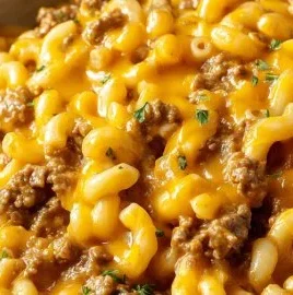Delicious cheesy hamburger helper served in a bowl with cheese and herbs