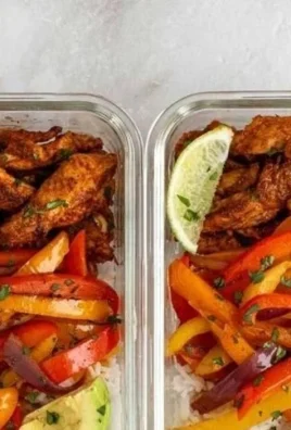 Chicken fajita meal prep bowls with colorful vegetables and spices