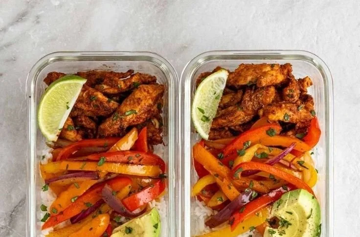 Chicken fajita meal prep bowls with colorful vegetables and spices